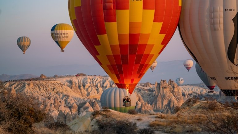 a group of hot air balloons flying in the sky