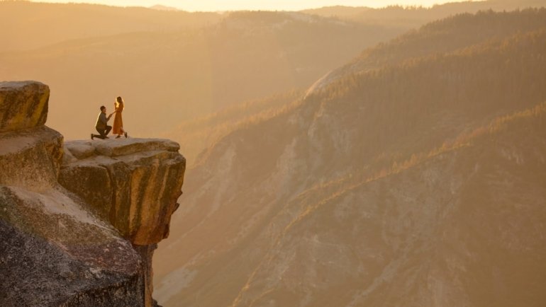 person sitting on rock formation during daytime
