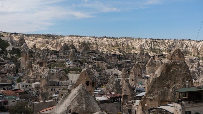 a view of a city in the middle of a mountain range