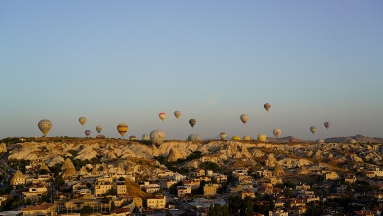 a group of hot air balloons flying over a city