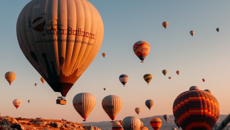 hot air balloons on brown field during daytime