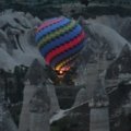 Hot air balloon floats above unique rock formations