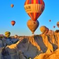a group of hot air balloons flying in the sky