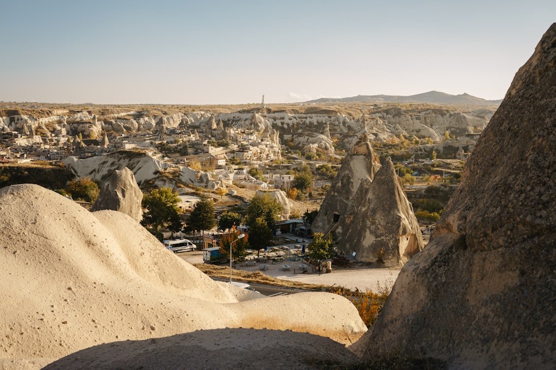 a rocky landscape with a road with Cappadocia in the background