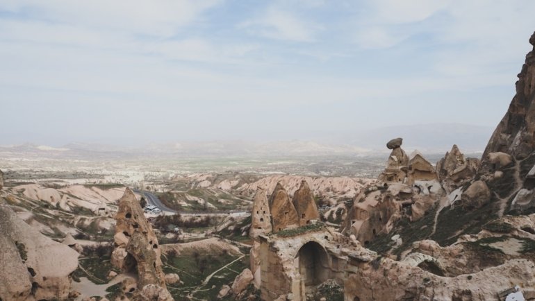 a rocky landscape with a stone structure
