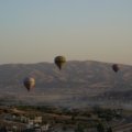 a group of hot air balloons flying over a city