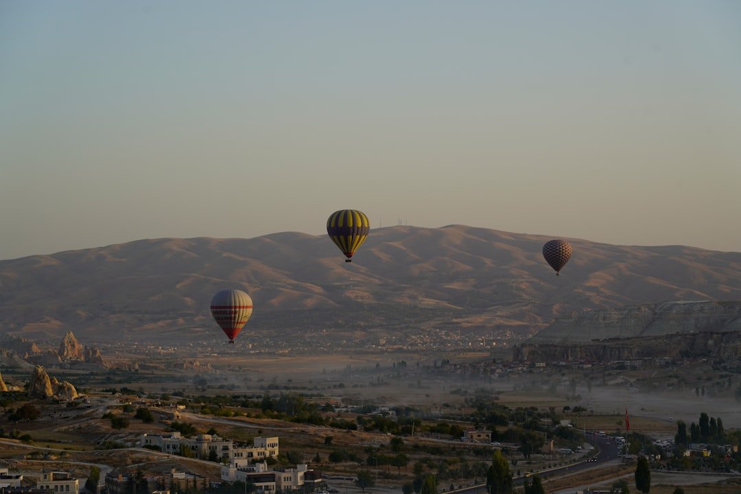 a group of hot air balloons flying over a city